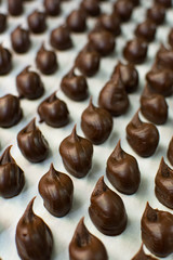 CLOSE UP OF HOW PREPARING MELTING HANDMADE DARK CHOCOLATE TRUFFLES DESSERT
