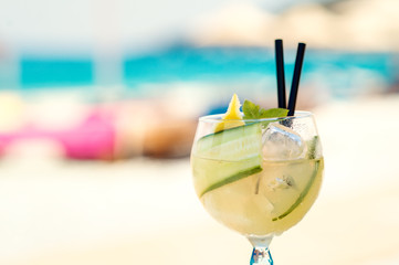 Cucumber drink cocktail, straw hat on wooden table