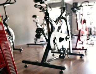 Spinning exercise bikes in gym room