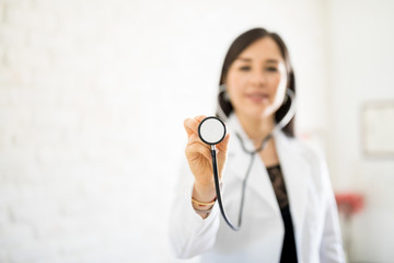 Female physician showing stethoscope