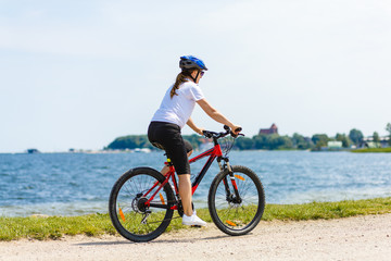 Healthy lifestyle - middle-aged woman riding bicycles 