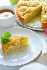 Slice of homemade apple pie on white plate. Tea time concept