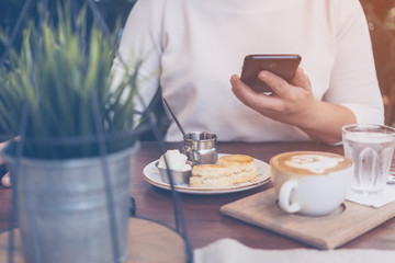 causal asian woman relax with smartphone in garden weekend time