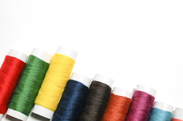 Set of colors thread for sewing on a white background.