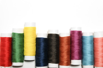 Set of colors thread for sewing on a white background.