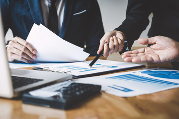 Executive team discussing the charts and graphs working in business strategy and financial plan to investment profit, discussing working analysis with financial data and marketing growth report