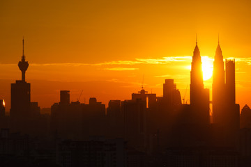 Fototapeta premium Majestic sunset over Twin Towers and surrounded buildings in downtown Kuala Lumpur, Malaysia. 