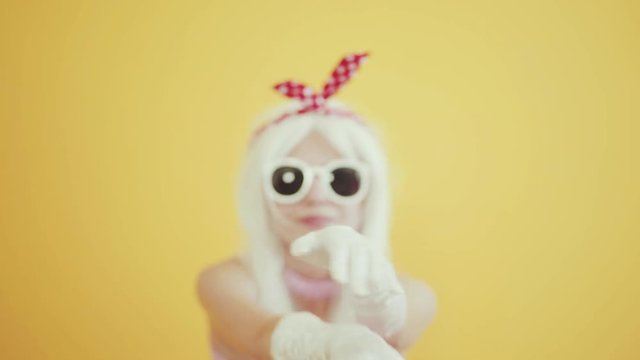 Blond girl with glasses in the image of anime doll
