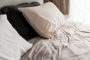 Fototapeta na wymiar beautiful soft white pillow on nice bed mattress bedroom interior deisgn home concept