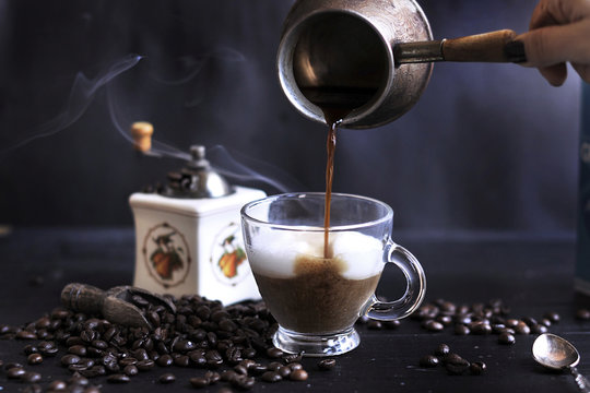 Preparation Of Aromatic Coffee With Foam And Milk. Dark Photo. Turkish Coffee. Copy Spce,