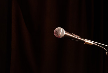 Obraz premium old acoustic microphone of a round form factor on a dark background