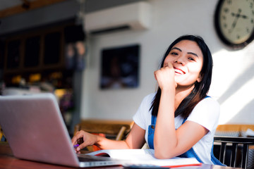 Obraz premium young students reading a book in coffee cafe; work at home.
