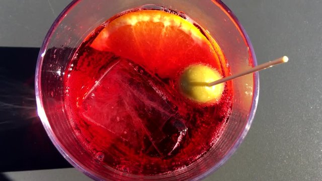Red bitter cocktail in a sunny day.