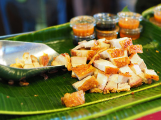 Pork crispy with Thai sauce selling in the market. Street food Thailand
