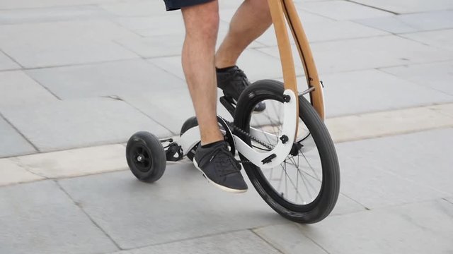 People riding halfbike - new trendy way to cycle city slow motion