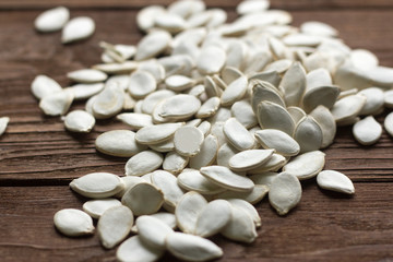 pumpkin seeds on wooden background