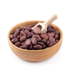 Cocoa fruit in a wooden bowl, raw cacao beans isolated on a white background