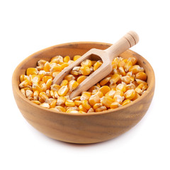 Corn seeds in a wooden bowl isolated on white background
