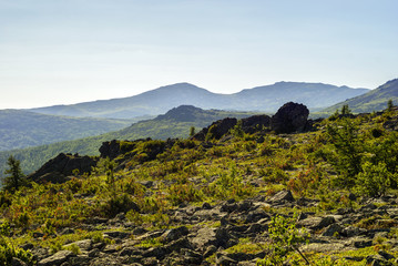 high-mountainous landscape of the Northern Urals in the vicinity of Mount Konzhakovskiy Kamen in a bright sunny day in the atmospheric haze