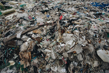 pile of garbage ; garbage dump . Waste from household in waste landfill