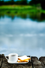 Breakfast set on wooden floor in the morning. Breakfast with coffee and bread.Do not focus on objects.