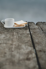 Breakfast set on wooden floor in the morning. Breakfast with coffee and bread.Do not focus on objects.