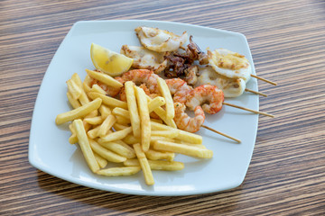 Fish skewers with fries