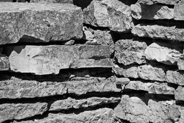 Heap of hewn rough stones, black and white photo