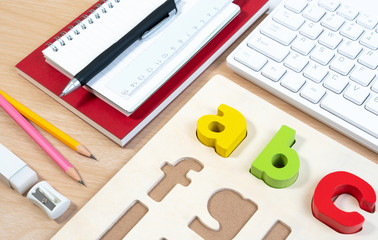 Close up of alphabet board game and basic equipment for elementary student. Wooden ABC alphabet game concept.