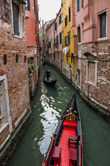 Venice, Italy. Gondolas in canal, narrow street