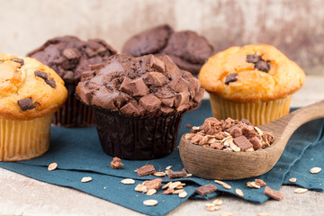 Homemade muffins with chocolate, vintage background.