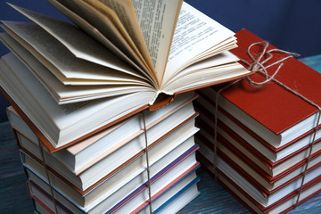 Education and reading concept - group of colorful books on the wooden table