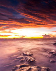 Fototapeta na wymiar Stunning view of sunset seascape with pinky sky. soft focus due to slow shutter.