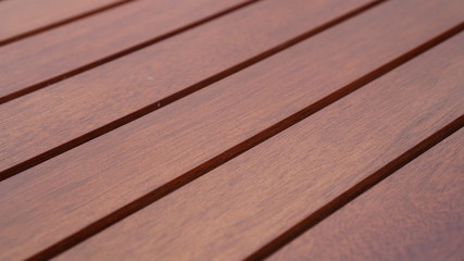 A close up of Horizontal red cedar wooden plank siding floorboards for use as a background or design element.