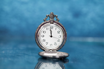 Old clock on blue background