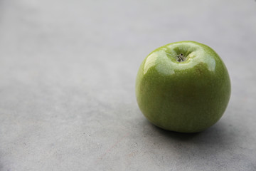 Fresh green Apple on grey background. Still life