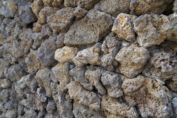 Close-up to rough stone wall background.