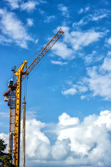 Towers of the cranes. Construction site with cranes against the blue sky.