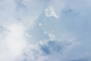 Isolated sky cloudscape with fluffy clouds and bright sun with soft rays during solar eclipse Virginia