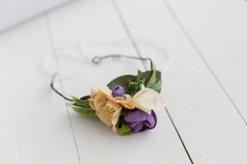 two wreaths . a wreath on the head. a wreath of orange and purple flowers. a wreath on the woman...