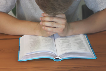 Naklejka premium Open Bible. The guy is reading the Bible