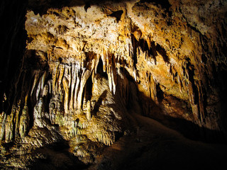Luray caverns in Virginia closeup of wet rocks in cave, with stalactites, stalagmites, and other formations