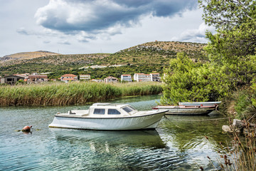 Boats with reflections in the beach bay, Pantan, Trogir, Croatia