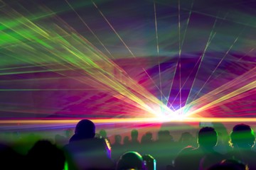 Hyper laser show. Very colorful show with a crowd silhouette and great laser rays at youth party...