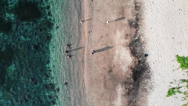 Stagnant aerial shot of a shore with a family bonding in Batanes, Philippines