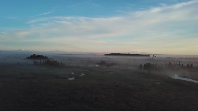 Beautiful foggy sunrise over the Kenai River flats at 5am in Alaska.