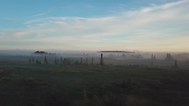 Beautiful foggy sunrise over the Kenai River flats at 5am in Alaska.