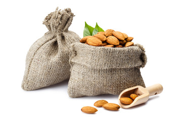Almonds in burlap sacks, isolated on white background