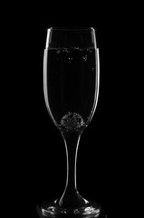 A glass for champagne with a glass ball and bubbles in monochrome