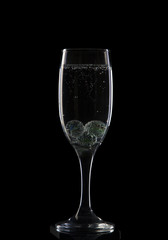 A glass for champagne with glass balls and bubbles